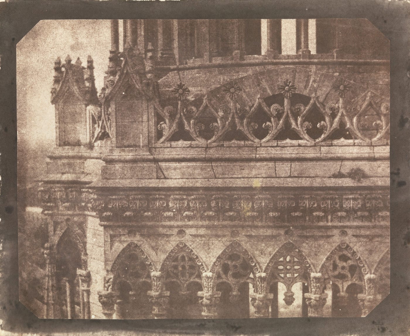 Brown early photograph of the carved Gothic stonework on the side of Orléans cathedral